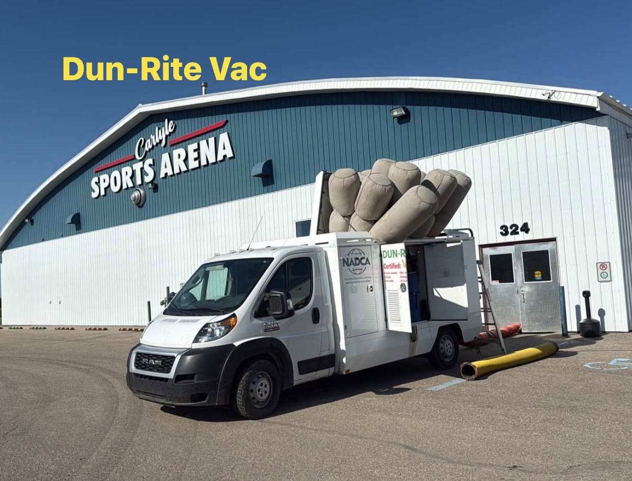 Dun-Rite Vac commercial vehicle parked outside a sports arena during a duct cleaning service call