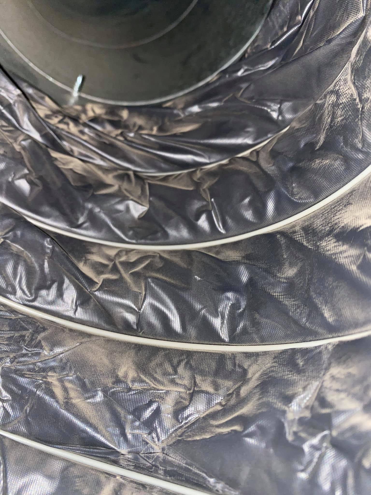 Close-up interior view of a wrinkled flexible insulated duct