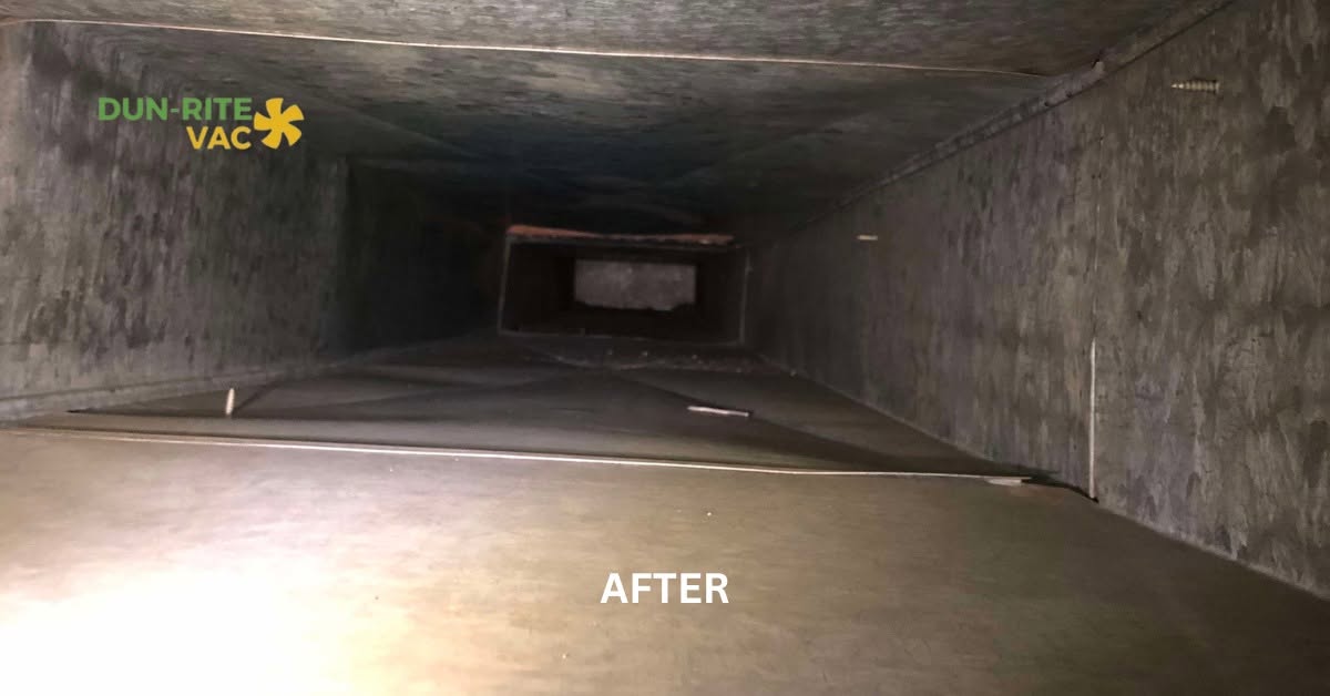 Interior of a main duct trunk line restored to bare metal after professional cleaning