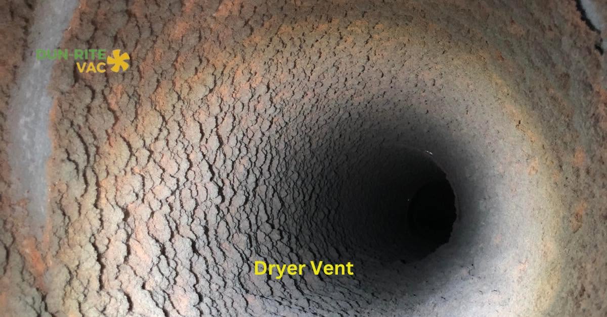 Interior view down a heavily rusted and dust-coated dryer vent duct