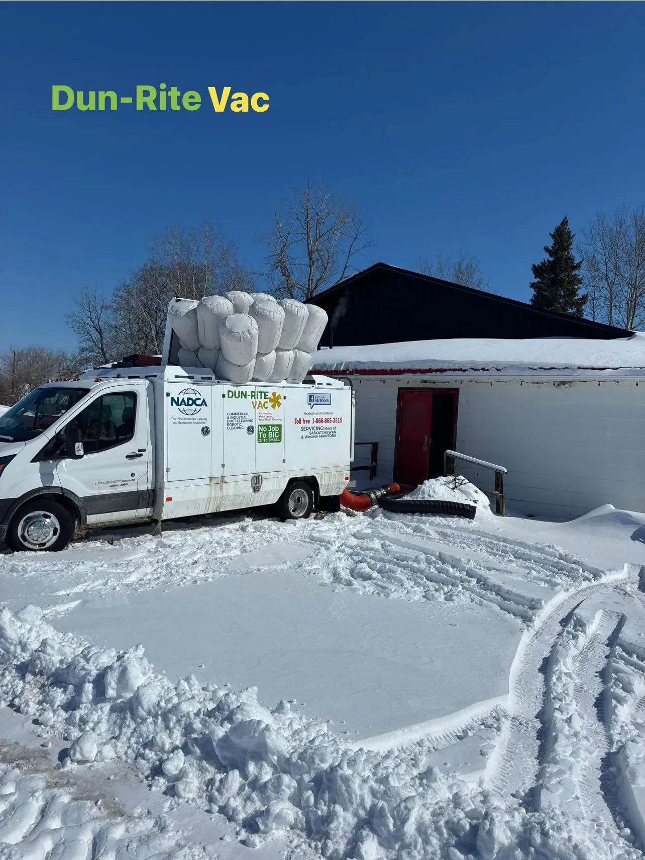 Truck-mounted air duct cleaning equipment servicing a Saskatchewan home during winter