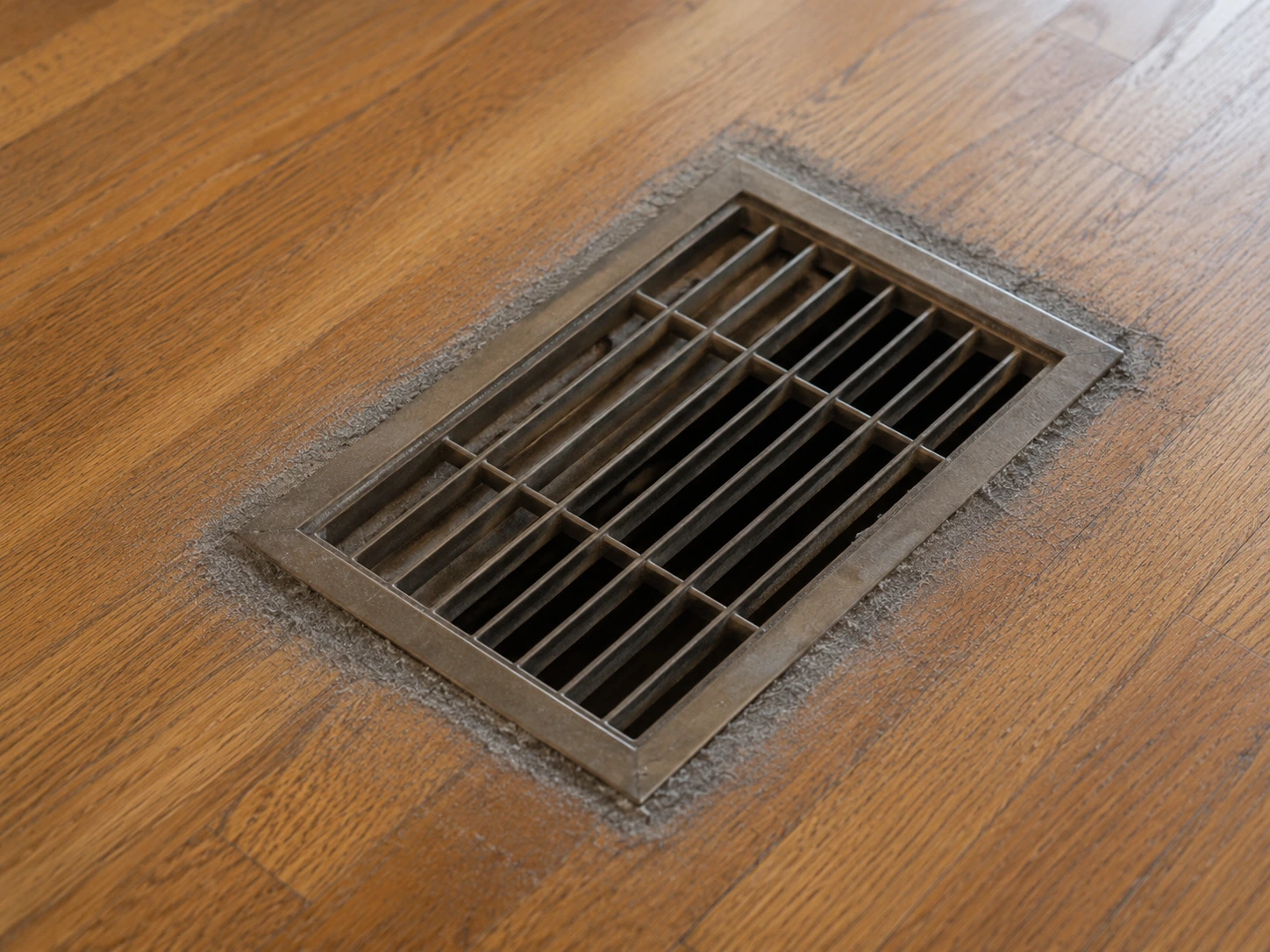 Dust buildup around a residential floor vent showing why dust coming from air vents often starts at the register.